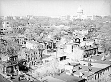 Wholesale demolition of the slums in Southwest D.C. (depicted) was a key goal of the Federal City Council. Looking northeast over Southwest Washington DC - July 1939.jpg