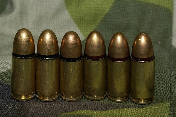 Swedish 9mm live ammunition m/39 (left, with black seal) and m/39B (right, with red seal and a slightly more pointed shape)