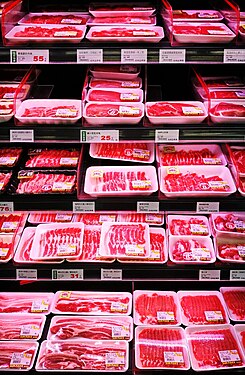 Meat under pink LED lighting in a meat refrigerator