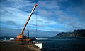 Crane on Kingston Pier unloading cargo from a lighter