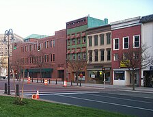Public Square's North Side. The modern office building on the left blends in with the 19th-century buildings to its right. North side of the Public Square in Watertown, New York.jpg