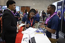 ONR staffer discusses paid internship opportunities with a visitor to the Department of the Navy Historically Black Colleges and Universities/Minority Institutions (HBCU/MI) Program exhibit. Office of Naval Research recruitment.jpg