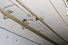 Two overhead conductor rails for the same track. Left, 1,200 V DC for the Uetliberg railway (the pantograph is mounted asymmetrically to collect current from this rail); right, 15 kV AC for the Sihltal railway Overhead conductor rails.jpg