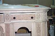 a closeup view of an ornately carved drawer front
