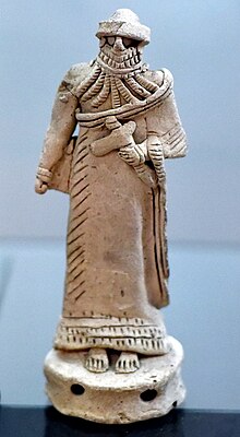 Terracotta male figurine holding an axe or adze, from Tell Telloh, Isin-Larsa period, c. 1900 BCE. Iraq Museum