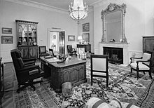 black and white image of the treaty room in 1992 with the Resolute desk sitting almost center in the room.