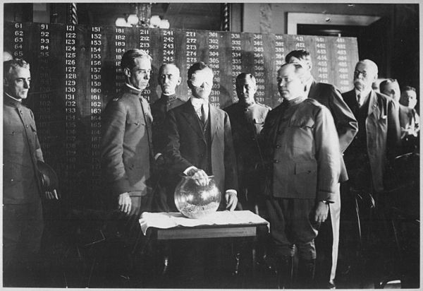 US Secretary of War Newton Baker drawing the first number in the World War I draft lottery, 1917