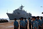 US Navy 080720-N-3446M-026 Members of the Indonesian navy stand pierside as the amphibious dock landing ship USS Tortuga (LSD 46) pulls into port at the Tanjung Perak commercial pier in Surabaya.jpg