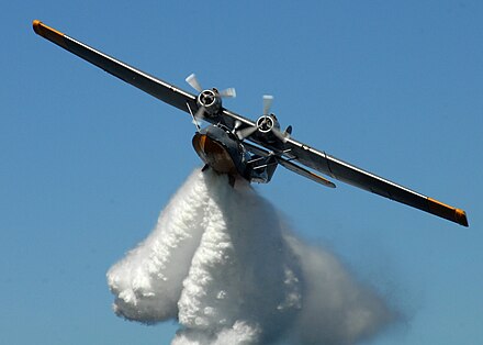 PBY-6A Catalina drops a load of water from its bomb-bay doors