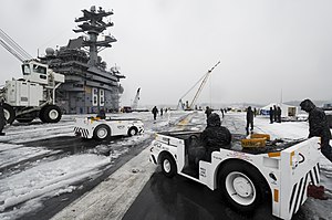 US Navy 120120-N-HN953-015 Sailors aboard the aircraft carrier USS Nimitz (CVN 68) remove snow from the ship's flight deck.jpg