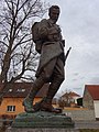 Bronzová socha vojína na památníku obětem I. světové války v Unhošti