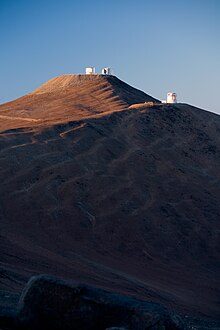 Early morning shot shows VISTA in front of the Paranal summit. VLT and VISTA in Early Sunlight.jpg