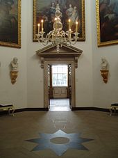 The Upper Tribunal looking towards the Gallery. Of note is the eight-pointed Garter star/Masonic Blazing Star in the centre of the floor with a painting of King Charles I in the background View of Upper Tribune from Portico.JPG