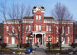 Image of a red-brick courthouse in autumn.