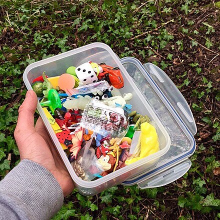 Many geocaches include various small and interesting items, such as small toys or cheap jewelry, and people are encouraged to replace the ones they take with other items they brought with them.