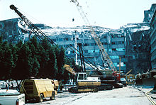 Mexico City - Collapsed upper stories and construction equipment at work at the Ministry of Telecommunications and Transportation building. 1985 Mexico Earthquake - Ministry of Telecommunications and Transportation building.jpg