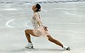 A lunge in figure skating – leading leg partial squatting, trailing leg straight back.