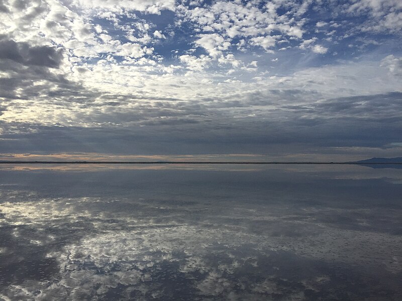 File:2015-09-29 08 56 48 View south-southeast from the end of the road to Bonneville Salt Flats International Speedway near Wendover, Utah, with calm waters covering the salt flats and reflecting the sky and mountains.jpg