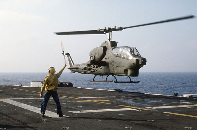 An AH-1T Sea Cobra launching from the amphibious assault ship Iwo Jima, July 1985.