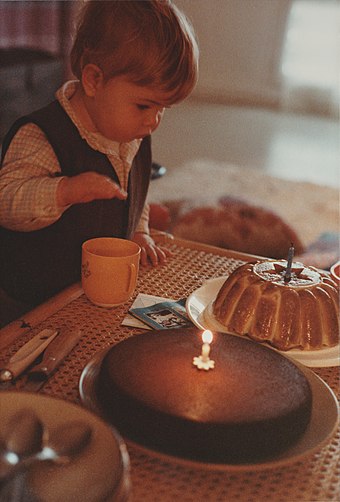 A young child preparing to extinguish the candle of his first birthday – 1983