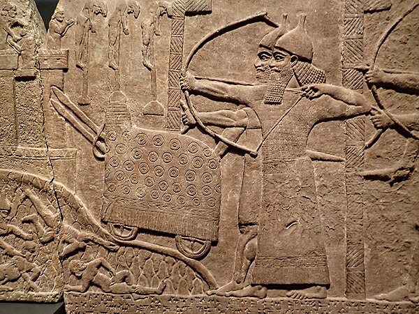 Siege engine in Assyrian relief of attack on an enemy town during the reign of Tiglath-Pileser III 743-720 BC from his palace at Kalhu (Nimrud)