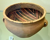 An earthenware bowl painted with red and black mineral pigment with ring handles, Gansu Province, Neolithic period, Yangshao culture, from the Garner Collection, in the Victoria and Albert Museum