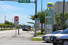 a bus stop and a level crossing on the South Miami-Dade Busway (2012) Busway level crossing.jpg