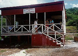 Canouan Airport's first terminal building in 1988, when the runway at the airport was an unpaved, sand and gravel airstrip. Canouan Airport original terminal building.jpg