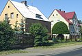 Polski: Domy mieszkalne (jednorodzinne) w Suchaniu, na drugim planie stary budynek policji(milicj)