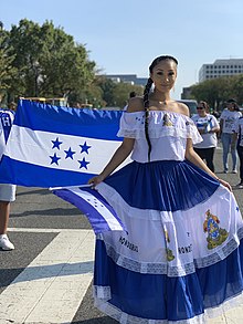 National flag and woman wearing national colours at the Fiesta DC 2019 Parade. Fiesta DC 2019 Parade.jpg