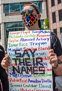 A protester holds a "Say Their Names" sign; many of the names are of African Americans who were unarmed when they were killed by law enforcement officers. George Floyd Protest, Columbus (May 30th) 02cIMG 2512 (49954044176).jpg