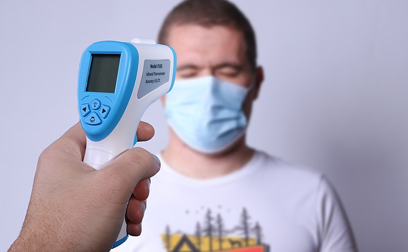 File:Hand holding non-contact infrared thermometer checking a person temprature. COVID-19 Concept.jpg