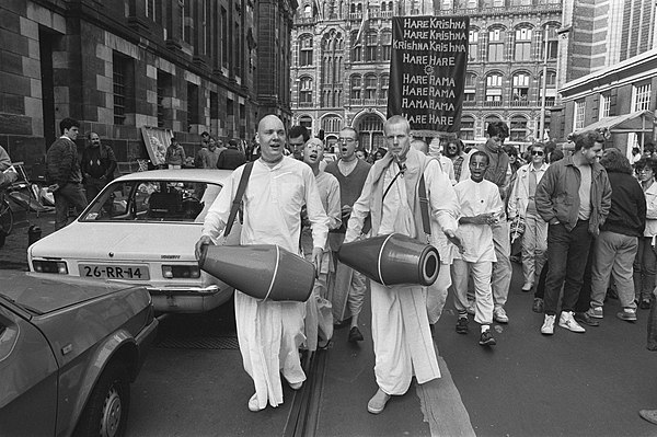 Hare Krishna devotees in Amsterdam carrying a poster with the Hare Krishna Mantra
