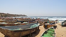 Fishing boats on Ouakam beach Hundreds of Senegalese traditional canoes ("pirogues") at Ouakam beach.jpg