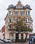 Tenement house in a half-open area in a corner, with a restaurant