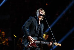 Keith Urban performs at the 2020 Library of Congress Gershwin Prize for Popular Song concert at DAR Constitution Hall in Washington, D.C.; Urban is playing a guitar and singing into the microphone.