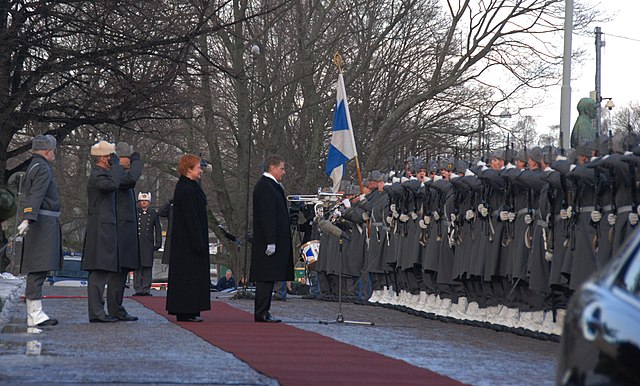 New President Sauli Niinistö (rt.) and outgoing President Halonen (2nd rt.) accompanied by military leaders, inspect the company of honor, c. 2012