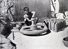 A potter with his pottery wheel, British Raj (1910) Pottery wheel before 1910.jpg