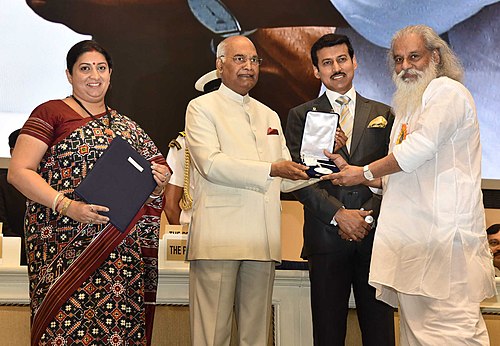 Ram Nath Kovind presenting the Rajat Kamal Award to Yesudas