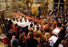 The tonsuring of readers in a seminary by a Russian Orthodox bishop. The readers being ordained are wearing the short phelon (in white). Reader ordination.jpg