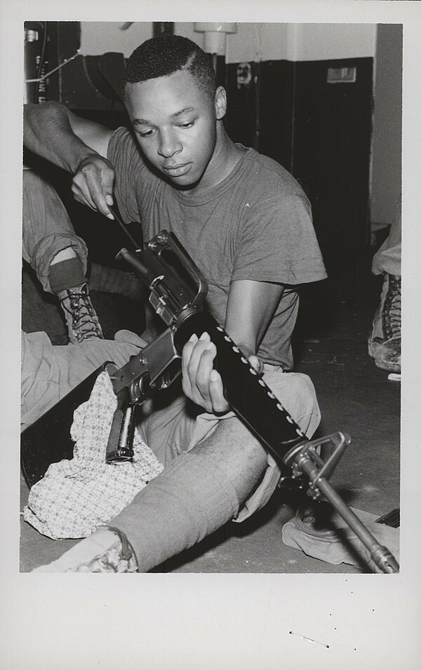 3/1 Marine cleans his XM16E1 in December 1967