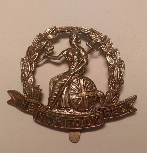 Cap badge of the Royal Norfolk Regiment.