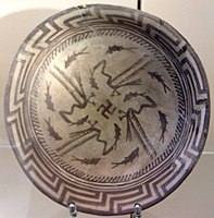 The Samarra bowl, from Iraq, circa 4,000 BCE, held at the Pergamonmuseum, Berlin. The swastika in the centre of the design is a reconstruction.[84]