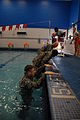 Sgt. Eric J. Glassey, Sgt. Kevin Frazier and Sgt. 1st Class Frank Minnie, all from 4th Public Affairs Detachment, climb out of the pool during Phase II Water Survival Training at Fort Hood, Texas, Aug. 24, 2011 110824-A-MG489-001.jpg