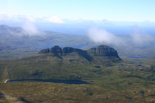 Suilven from the air, showing the steep-sided mountain slopes and rough moorland landscape typical of Assynt.
