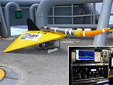 The towed pinger locator on the deck of a vessel. An inset shows a rack of electrical equipment. TPL-25.jpg