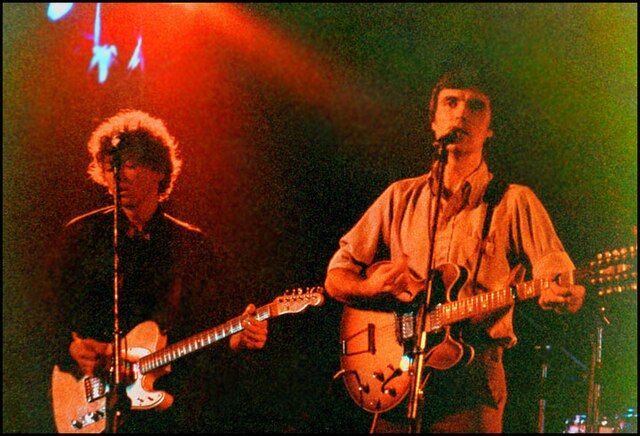 Talking Heads perform. Pictured: Harrison (left) and Byrne.