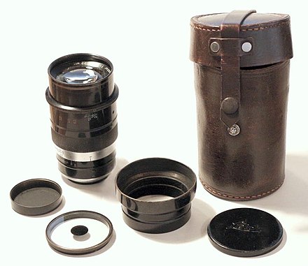 Very rare Leica soft-focus Thambar lens from the 1930s with original leather case. In front, left to right: Rear cap, special dot filter, lens shade, front cap.