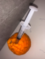 Wrinkled Orange with a syringe stabbed in.png