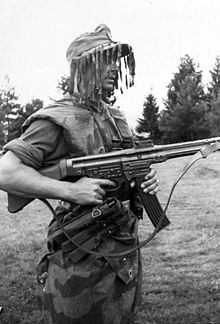 A German infantryman armed with an StG 44, wearing "splinter" camouflage and a ghillie cap in July 1944. Bundesarchiv Bild 101I-676-7996-13, Infanterist mit Sturmgewehr 44.jpg